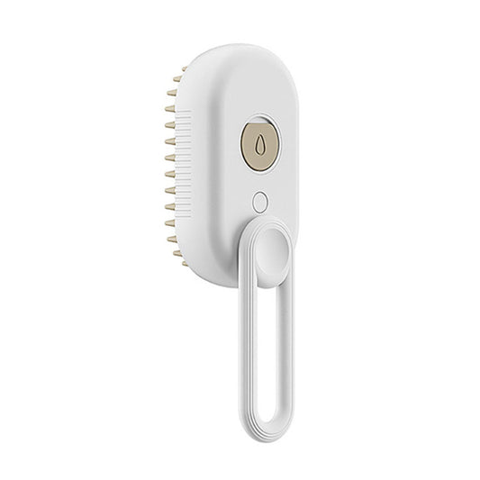 A white electric hair grooming brush with a hanging loop, featuring a circular power button with a gold accent and bristles on the side, shown against a plain white background.