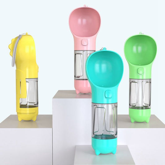 Four pet water bottles with integrated bowls in yellow, pink, turquoise, and green, displayed on white pedestals against a light gray background.