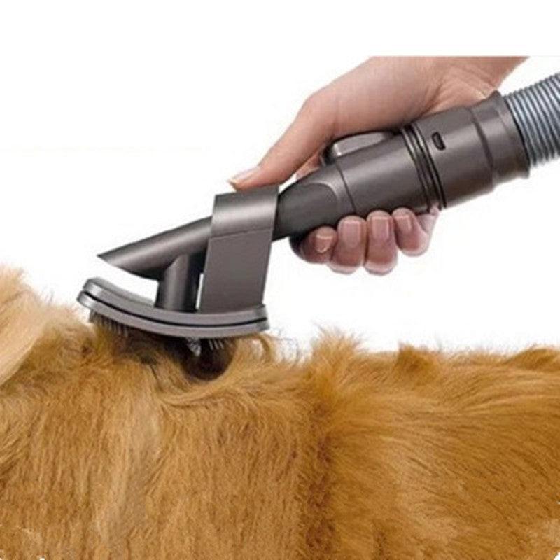 A close-up of a dog grooming attachment being used on a golden retriever's fur, with a human hand holding the tool against a white background.