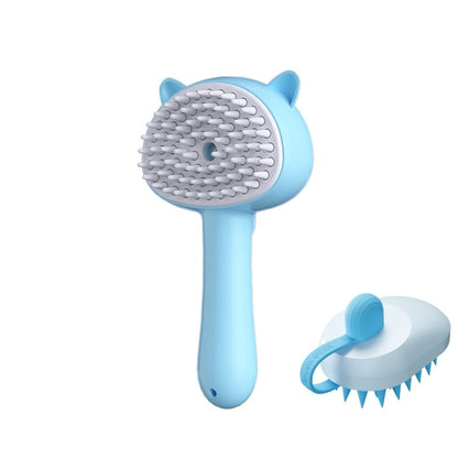 A light blue and white pet grooming brush with cat-ear details on the handle, shown alongside a smaller detached brush attachment on a plain white background.