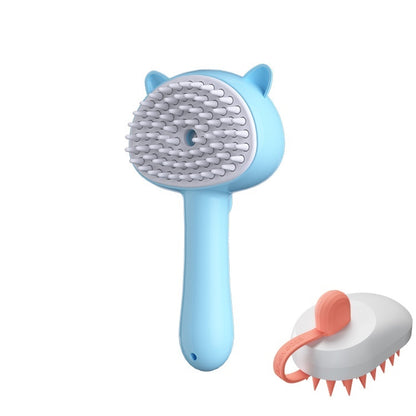 A light blue pet grooming brush with cat-ear details and white bristles, shown alongside a smaller detached view of the brush head with coral-pink bristles and handle loop on a plain white background.