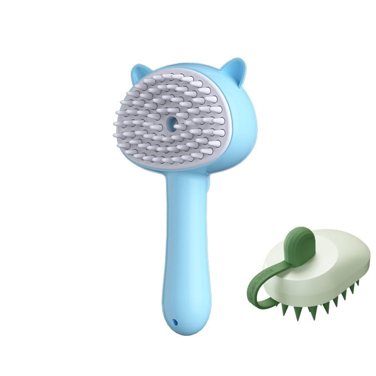 A light blue pet grooming brush with cat-ear details and white silicone bristles, shown alongside a smaller green-and-white alternative brush on a plain white background.