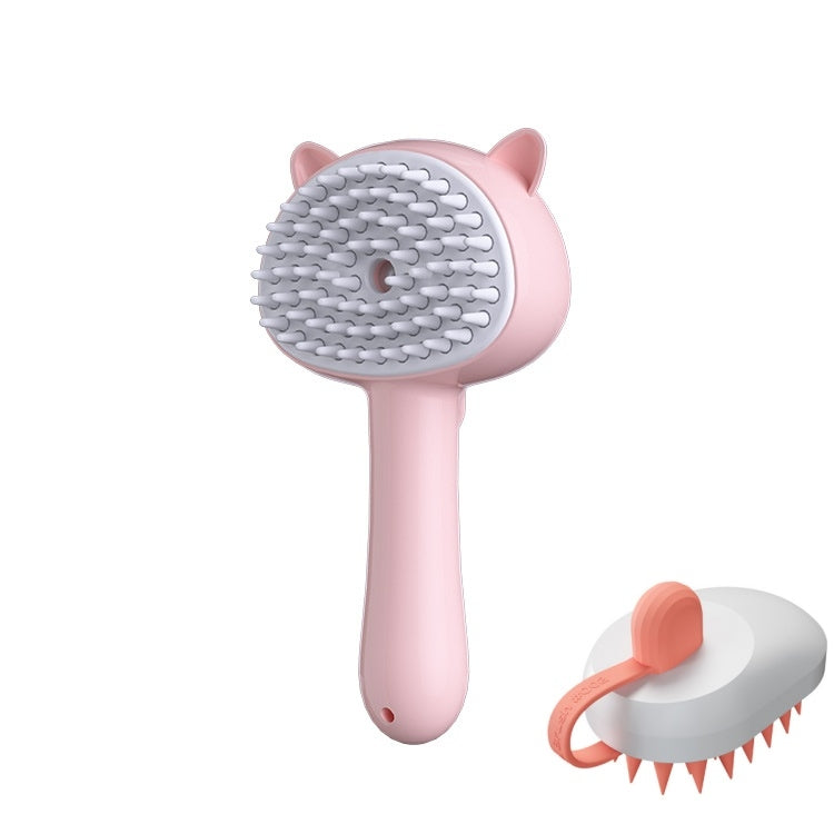 A pink and white pet grooming brush with cat-ear details on the handle and head, shown alongside a smaller inset view of the brush from the back on a plain white background.