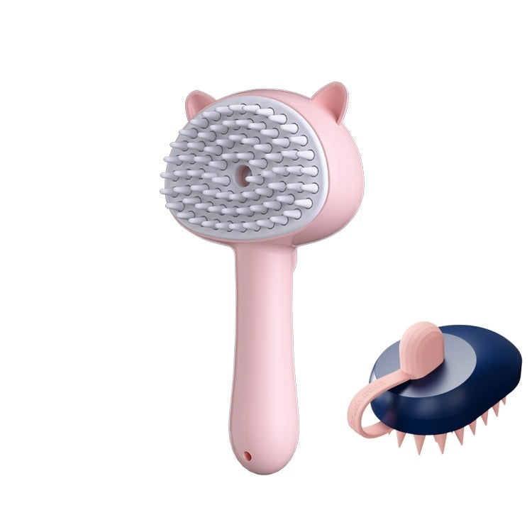 A pink pet grooming brush with cat-ear details and a white silicone bristle head, shown alongside a smaller inset view of the brush from the back with a dark blue base and pink handle.