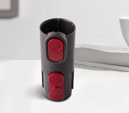 Black and red cylindrical device on a white surface with a neutral background