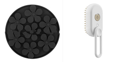 Black silicone mold with flower shapes and a white handheld cleaning brush on a white background