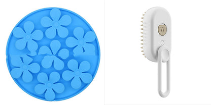Blue flower-shaped ice cube tray and white handheld brush on a white background