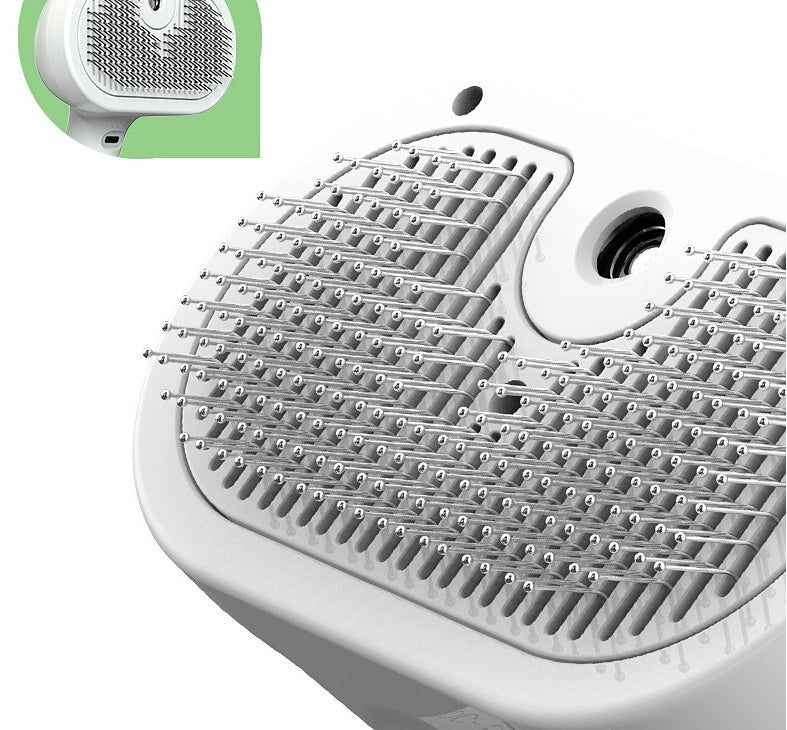Close-up of a white electronic device with a green label on a white background
