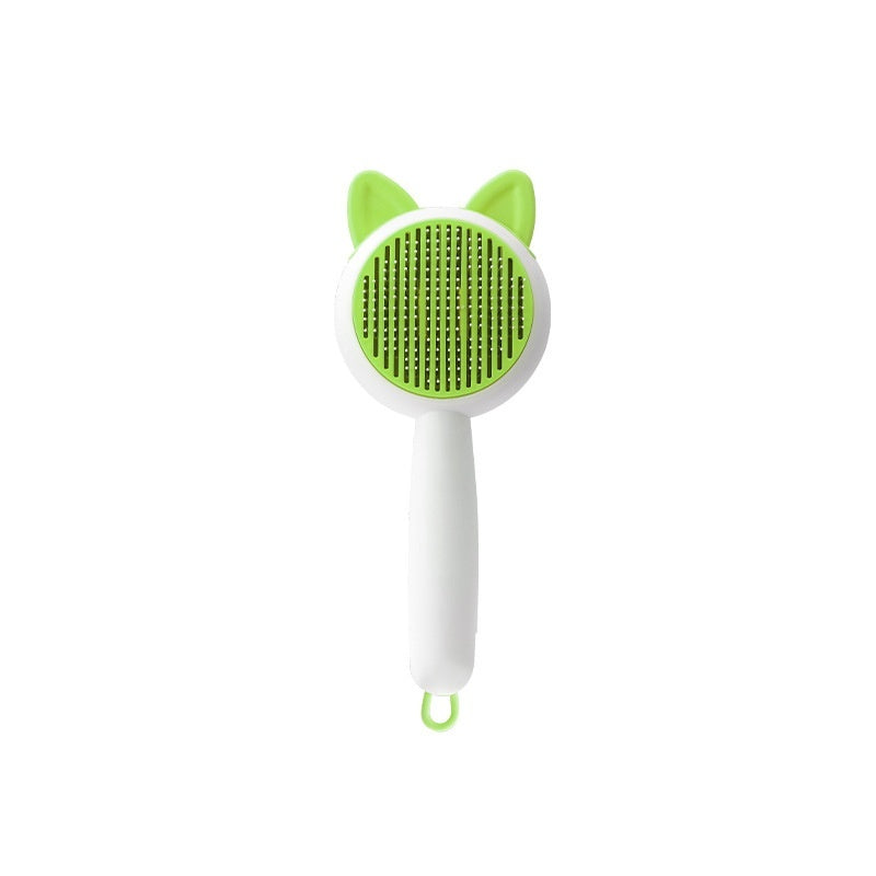Green and white pet grooming brush with cat ear design on a white background