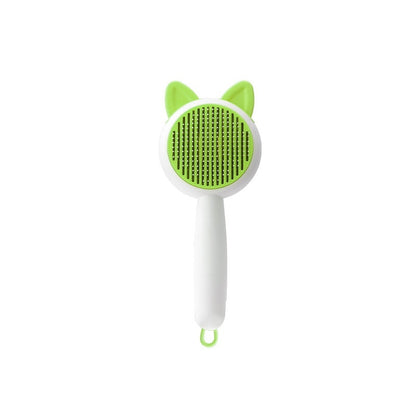 Green and white pet grooming brush with cat ear design on a white background