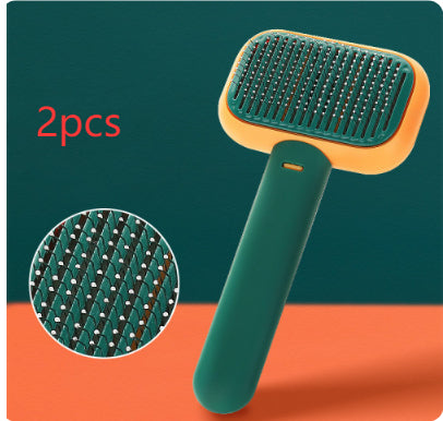 Pet grooming brush with green handle and orange bristles on a teal and orange background.