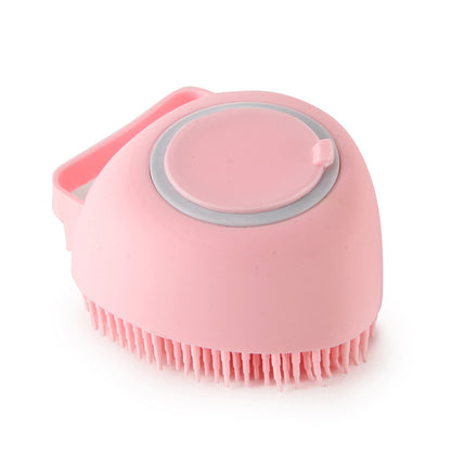 Pink silicone scrubber with bristles on a white background