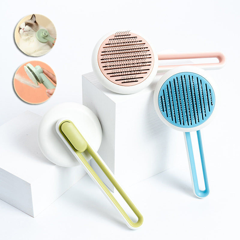 Three pet grooming tools in green, pink, and blue on a white background.