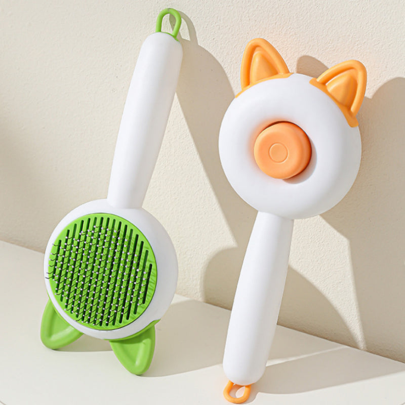 Two pet grooming tools with green and orange designs on a light background