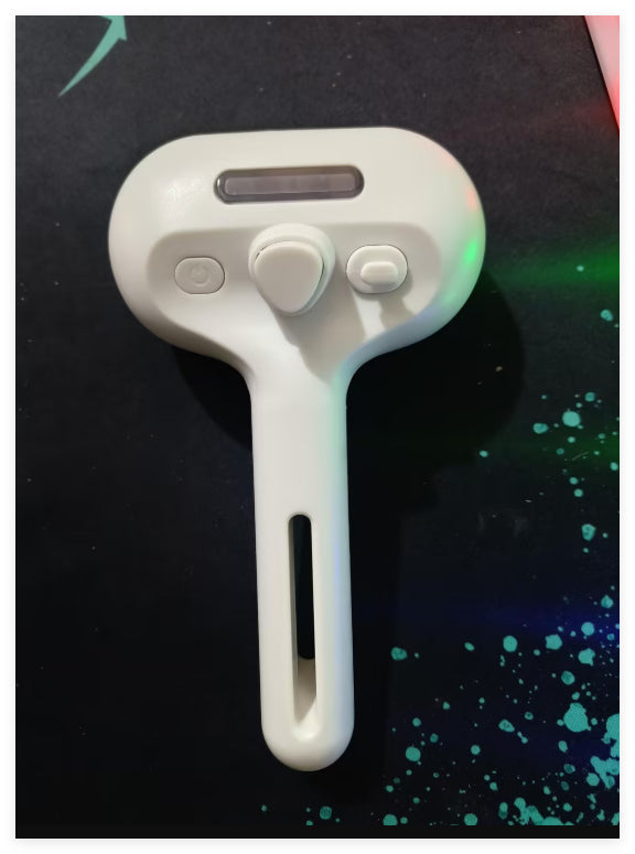 White handheld device with buttons on a dark background