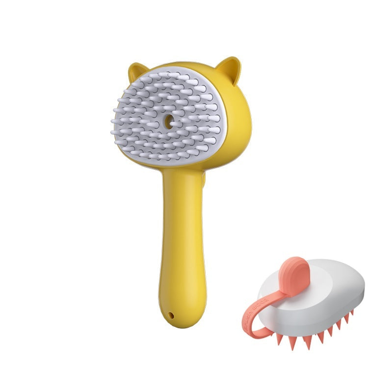 Yellow pet grooming brush with a white bristle pad and cat-ear detail, shown alongside a smaller view of the brush with pink-tipped bristles and a pink loop handle on a white background.