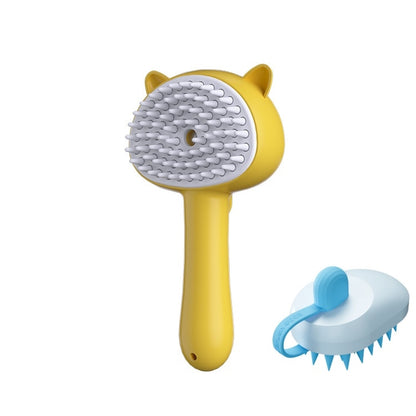 Yellow pet grooming brush with cat-ear details and a white bristle pad, shown alongside a smaller blue-and-white alternative brush on a plain white background.