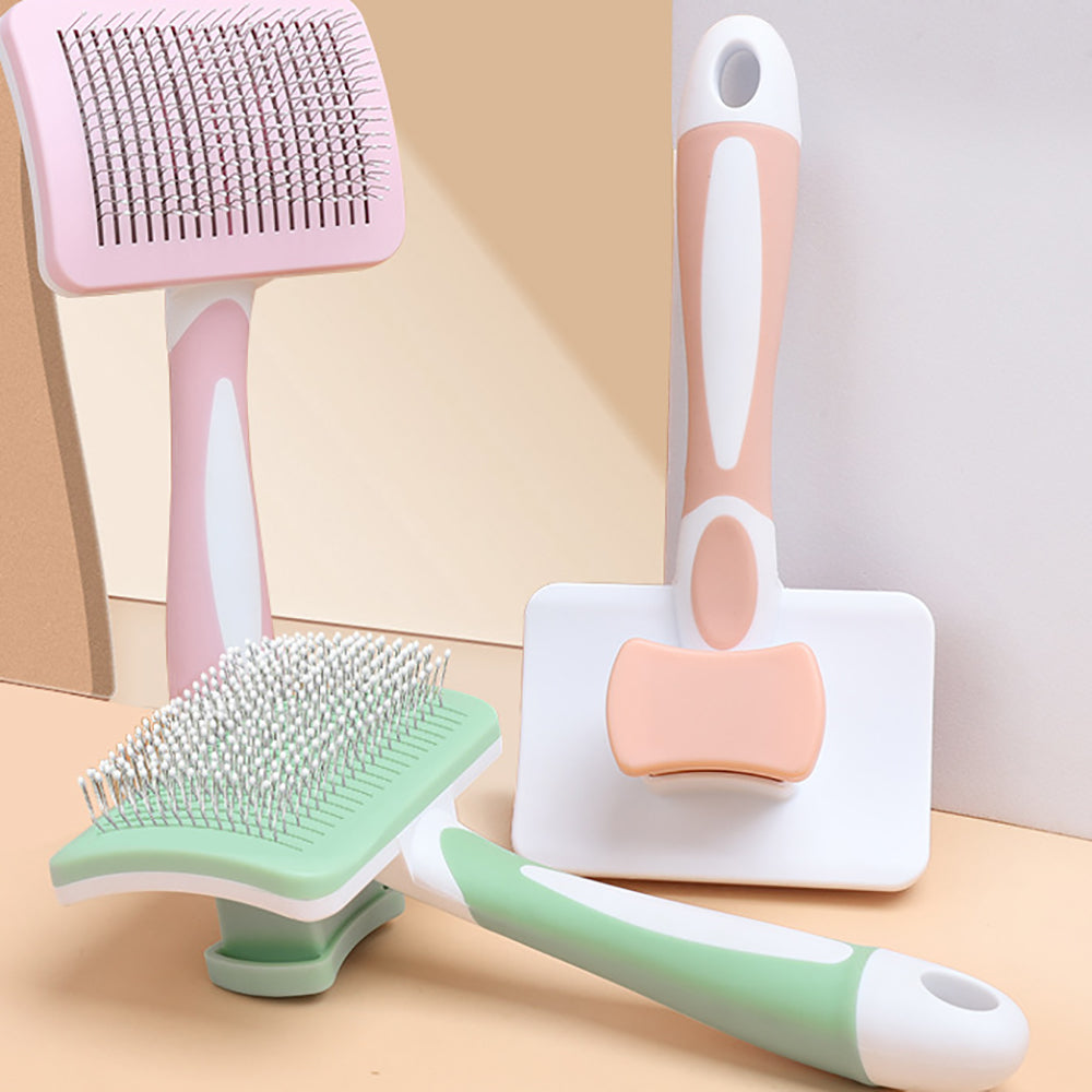 Set of pet grooming tools including brushes and a comb on a neutral background
