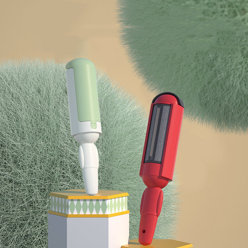 Two grooming tools, one green and white, one red and black, on a textured grass background.