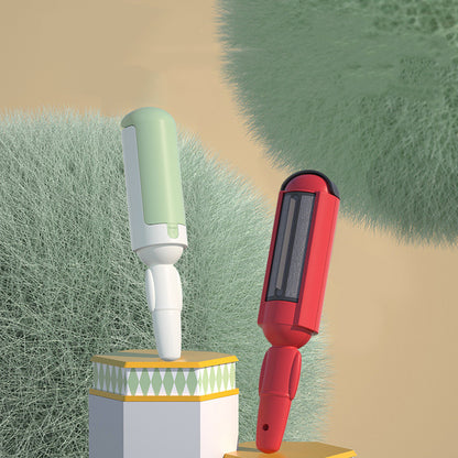 Two grooming tools, one green and white, one red and black, on a textured grass background.