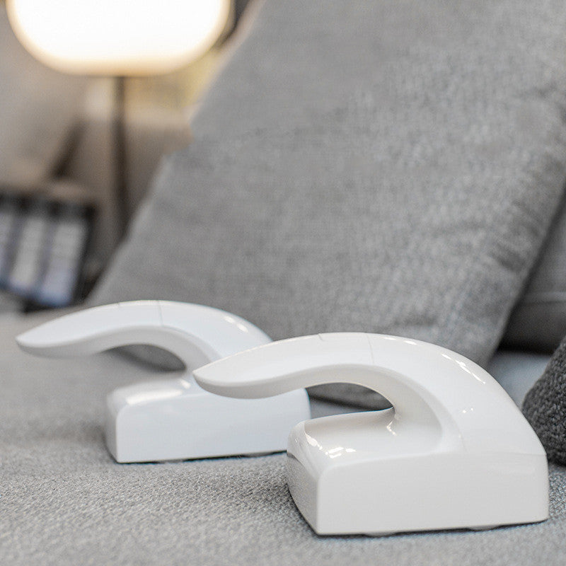 White plastic door stopper on a gray surface with a blurred background