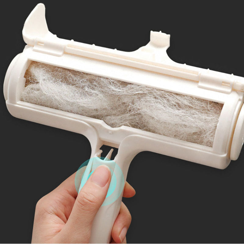 Hand holding a pet hair removal roller with collected pet hair on a black background