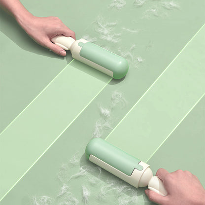Green and white cleaning tool being used on a green tiled floor.